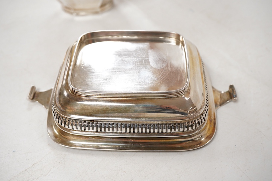A George V silver two handled butter dish, by George Howson, Sheffield, 1928, 16.7cm over handles, together with a George V silver cream jug, by William Suckling Ltd, Birmingham, 1931, 10.7oz.